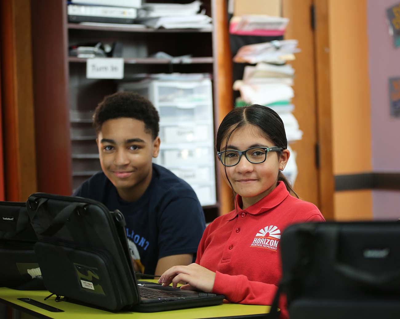 Teacher or school staff member warmly interacting with a student outside